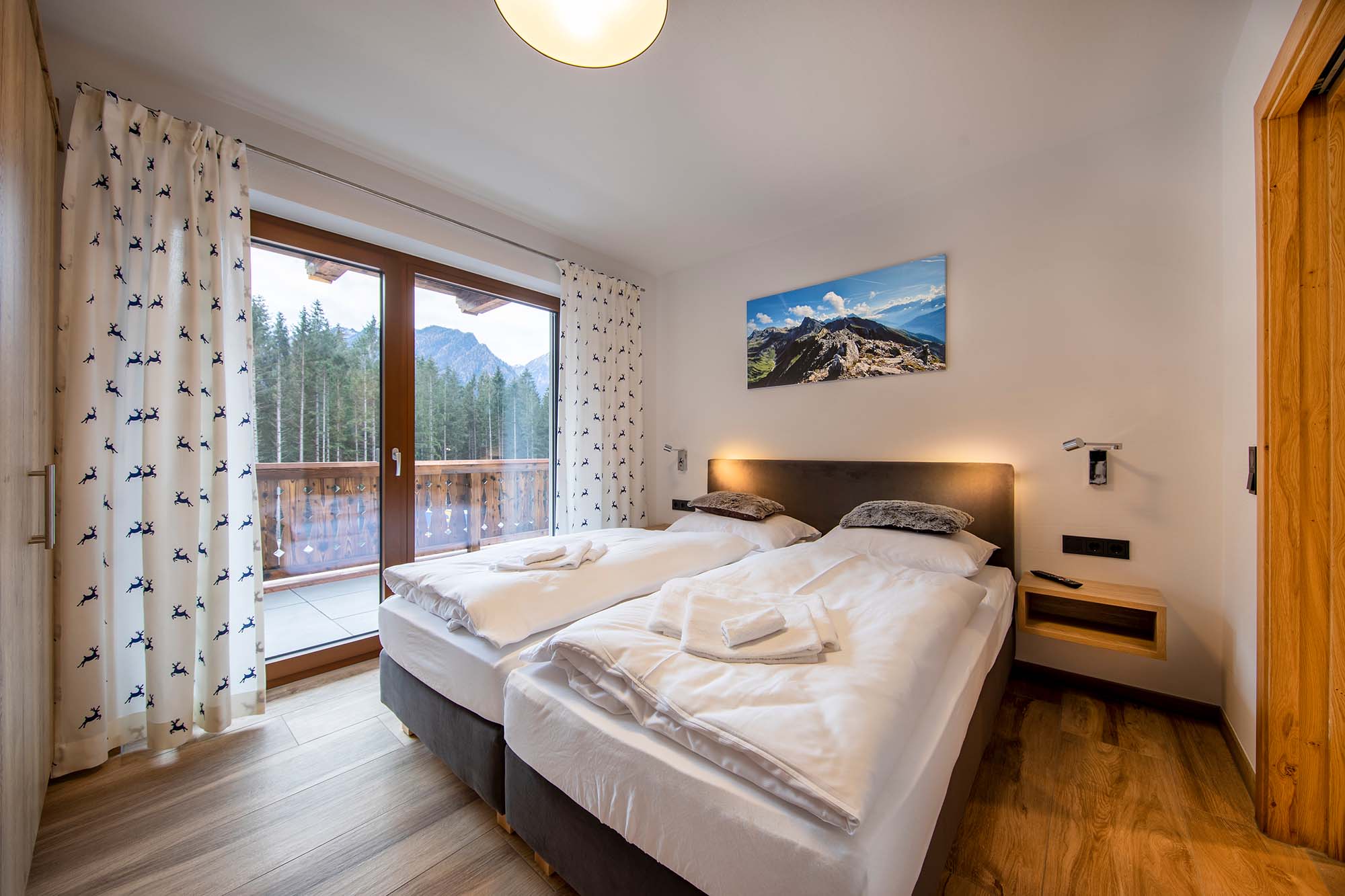 Schlafzimmer mit Holzboden und Balkon